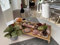 a plate of food on a table with a bottle of wine at Aurefees in Ellon