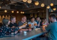 a group of people sitting around a table drinking at The Millennials Kyoto in Kyoto