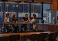 a group of people sitting at a table in a restaurant at The Millennials Kyoto in Kyoto