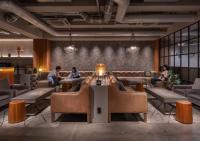a group of people sitting on couches in a lobby at The Millennials Kyoto in Kyoto