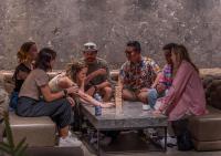 a group of people sitting around a table at The Millennials Kyoto in Kyoto