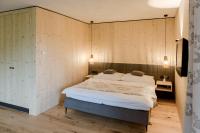a bedroom with a bed in a room with wooden walls at Haus Widmann in Fieberbrunn