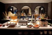 a kitchen with a counter with bowls of food on it at The Quartier Hotel Phromphong - Thonglor in Bangkok