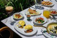 a table with plates of food and drinks on it at Hotel Poli Urban By AFI Hotels in Tel Aviv