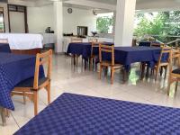 a dining room with blue tables and chairs at HOTEL HIPPO BUCK in Homa Bay