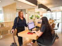 two women standing at a desk in a store at ibis Itu Plaza Shopping in Itu