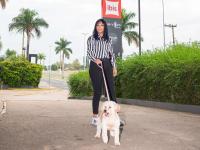 a woman is walking a dog on a leash at ibis Itu Plaza Shopping in Itu