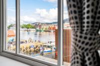 a window with a view of a river and buildings at Magic Hotel &amp; Apartments Kløverhuset in Bergen