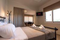 a bedroom with a bed with two pillows on it at Demi&#39;s Apartments Near Athen&#39;s Airport in Artemida