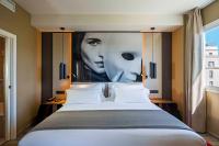 A bed or beds in a room at NH Collection Madrid Suecia