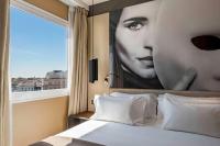 A bed or beds in a room at NH Collection Madrid Suecia