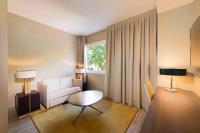 A bed or beds in a room at NH Collection Madrid Suecia