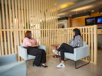two women sitting in chairs in a waiting room at ibis Itu Plaza Shopping in Itu
