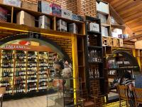 a store filled with lots of bottles of wine at Italian Palace Hotel in Sinop