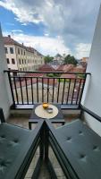 a small table on a balcony with a view of a city at TiM LUX 3 in Čačak