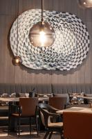 a dining room with tables and a large chandelier at AC Hotel by Marriott Chengdu North in Chengdu