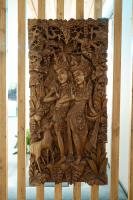 a wooden carving of two people on a wall at Suite and Spa la Perla Bianca in Grabels