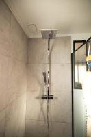 a shower with a shower head in a bathroom at Suite and Spa la Perla Bianca in Grabels