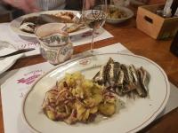 a plate of fish and potatoes on a table at Bracera Inn in Malinska
