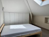a bedroom with a bed with white cabinets at Appartement Urrugne, 3 pièces, 5 personnes - FR-1-239-931 in Urrugne