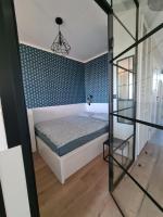 Posteľ alebo postele v izbe v ubytovaní Apartament lazurowy