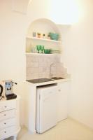 a white kitchen with a sink and a counter at Casa Mulini in Positano