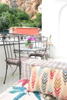 a patio with two chairs and a table with flowers at Casa Mulini in Positano