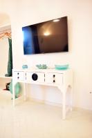 a white desk with a tv on top of it at Casa Mulini in Positano