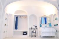 a white room with a white dresser and a mirror at Casa Mulini in Positano