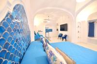 a bedroom with a blue bed with a blue headboard at Casa Mulini in Positano