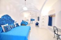 a bedroom with a blue bed in a room at Casa Mulini in Positano