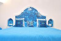 a blue bed with a blue headboard and pillows at Casa Mulini in Positano