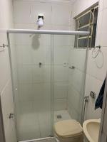 a bathroom with a shower with a toilet and a sink at Casarão Hostel in Guaratinguetá