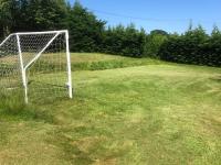 a soccer goal in the middle of a field at Daisy Cottage with seasonal Swimming Pool in Le Mesnil-Gilbert