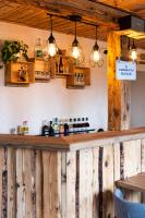 un bar dans un restaurant avec des lumières sur le mur dans l'établissement Le Charmagit, à La Roche-sur-Foron
