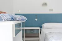A bed or beds in a room at Hotel Lucerna