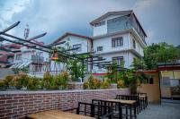 a group of tables and chairs in front of a building at Hotel Matina Suites in Pokhara