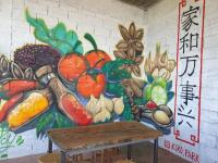 a wall with a painting of fruits and vegetables at Doichang view in Ban Huai Khai