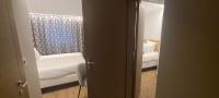 a room with a couch and a chair and a window at Geographotel Paris-Roissy CDG Airport in Le Mesnil-Amelot