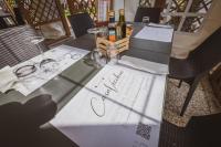 a table with wine glasses and a wedding invitation at Camping Casavecchia - Empty Pitch in Ledro
