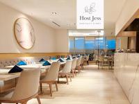 a dining room with tables and chairs and a sign at Gold Coast PIK Apartments by Host Jess in Jakarta