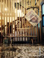 a wooden chair sitting in front of a staircase at Sweetlight B&amp;B in Jiaoxi