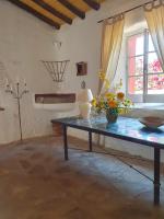a living room with a table with flowers on it at Hotel Rural El Vaqueril in Navas del Madroño