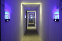 a corridor of a hallway with purple lights at Hsiangkelira Hotel in Kaohsiung