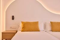 Łóżko lub łóżka w pokoju w obiekcie Universal Hotel Bikini