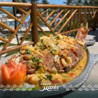 a plate of food with shrimp and vegetables on a table at Hotel das Marés in Trairi