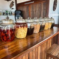 a row of jars of food on a wooden counter at Doany Beach in Antafondro