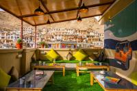 a restaurant with tables and a view of a city at LeHostel in Leh