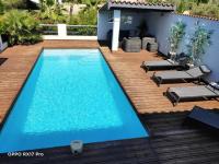 an image of a swimming pool on a wooden deck at Lavocette maison appartement in Le Grau-dʼAgde