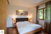 Łóżko lub łóżka w pokoju w obiekcie Haus Percha Mountain Apartments